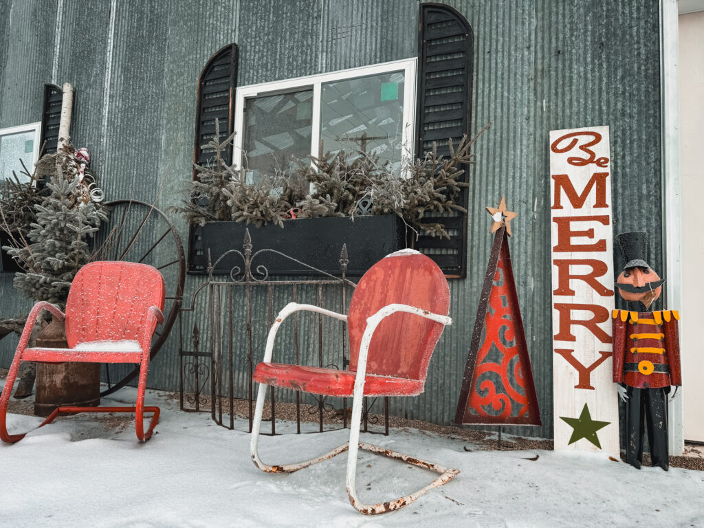 Outdoor view of new greenhouse with steel cladding and winter decor at Junque Decor Floral and Greenhouse